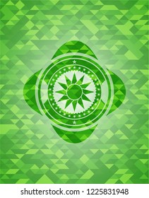 sun icon inside green emblem with mosaic background
