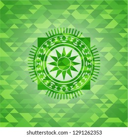 sun icon inside green emblem. Mosaic background