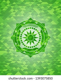 sun icon inside green emblem with mosaic ecological style background
