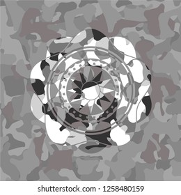 sun icon inside grey camo emblem
