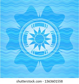 sun icon inside light blue water wave style emblem.