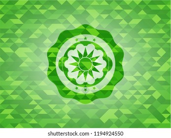 sun icon inside realistic green mosaic emblem