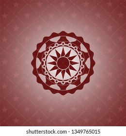 sun icon inside red emblem