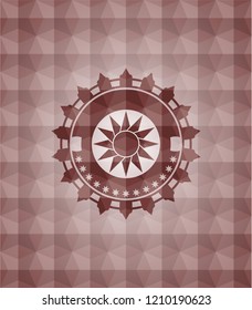 sun icon inside red seamless emblem or badge with abstract geometric polygonal pattern background.