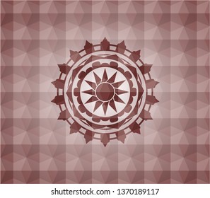 sun icon inside red seamless emblem with geometric pattern background.