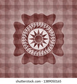 sun icon inside red seamless geometric emblem.