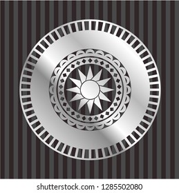 sun icon inside silver emblem or badge