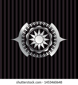 sun icon inside silver emblem or badge