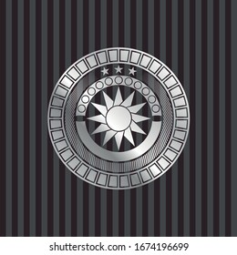 sun icon inside silver emblem or badge
