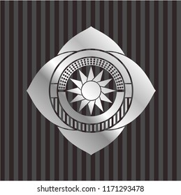 sun icon inside silvery badge