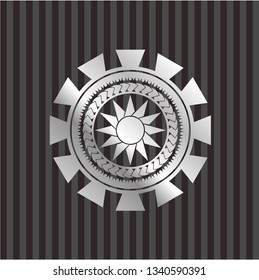 sun icon inside silvery badge or emblem