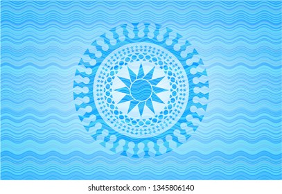 sun icon inside sky blue water wave badge.