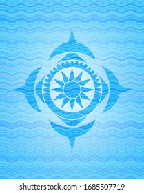 sun icon inside sky blue water wave badge.