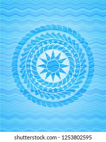 sun icon inside water wave representation badge background.