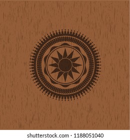 sun icon inside wood emblem