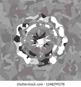 sun icon on grey camo texture