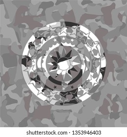 sun icon on grey camo texture