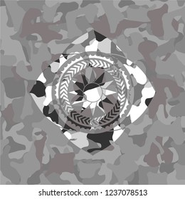 sun icon on grey camouflaged texture