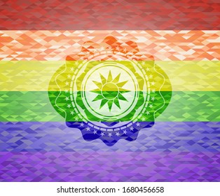 sun icon on mosaic background with the colors of the LGBT flag