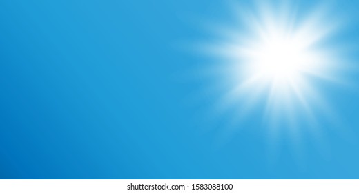 The sun on the blue sky shines with sultry bright rays of summer.