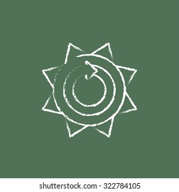 Sun with round arrow hand drawn in chalk on a blackboard vector white icon isolated on a green background.