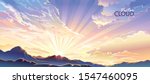 The sun setting behind the mountains and emitting radiant rays of light.