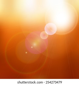 sun shining brightly on blurred orange background