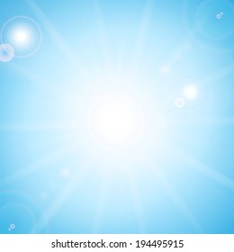 Sun and sunbeams on the background of blue sky 