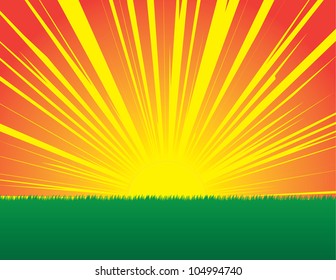 Sunburst sunset in grassy field