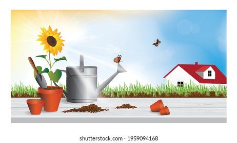 Sunflower in pot, garden tools on a wooden table, orange monarch butterflies, grass and a house in the distance against the backdrop of the sky and the bright sun. 