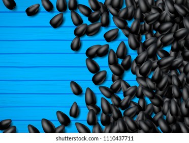 Sunflower seeds background with heap of scattered black grains