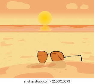 Sunglass on the beach, at sunset