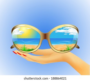 Sunglasses with the reflection of the summer sea landscape lie on hand