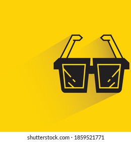 sunglasses with shadow on yellow background