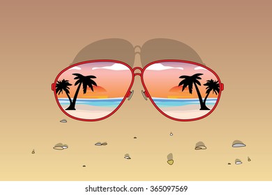 Sunglasses with sunset reflection at beach.