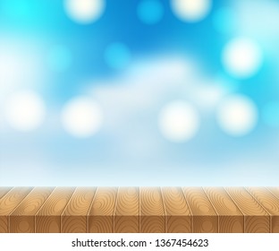 Sunlight on summer sky with wooden picnic table