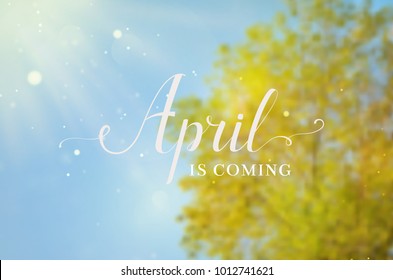 Sunny April background. Blurred spring design with green tree, blue sky, sunlight and hand lettering. Vector.