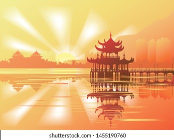 Sunrise over a Buddhist temple reflected in the water. Travels in South Asia.