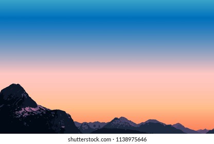 Sunset against the background of a high snow mountain