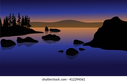 At Sunset in beach with rock and spruce silhouette 