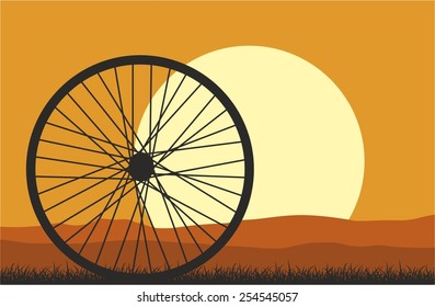 Sunset Landscape in the steppe with a bicycle wheel.