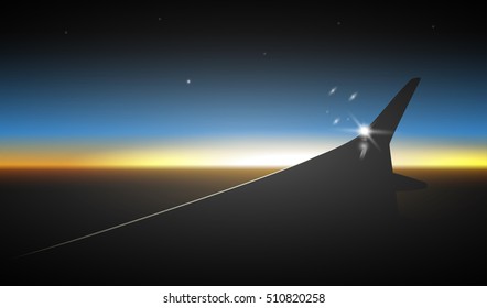 Sunset sky as seen through window of an aircraft, wing of flying plane.