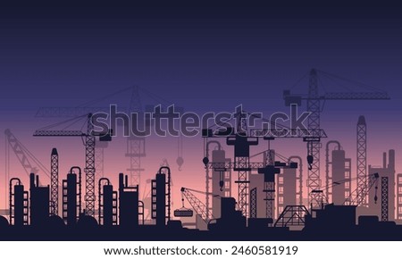 Sunset view and tower crane silhouette on construction site