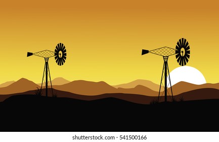 At sunset windmill scenery of silhouettes