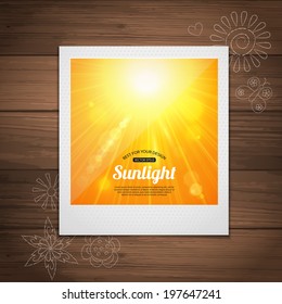 Sunshine background with blurred bokeh lights over wooden surface. Yellow summer sun light burst.