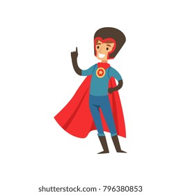 Superhero boy character dressed in blue costume, red cape and black helmet standing with raised index finger cartoon vector Illustration