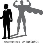 A superhero business man revealed by his shadow silhouette as a super hero in a cape