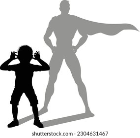 A superhero child or kid boy revealed by his shadow silhouette as a super hero in a cape.