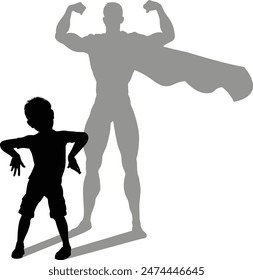 A superhero child or kid boy revealed by his shadow silhouette as a super hero in a cape.