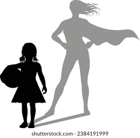 A superhero child or kid girl revealed by her shadow silhouette as a super hero in a cape.